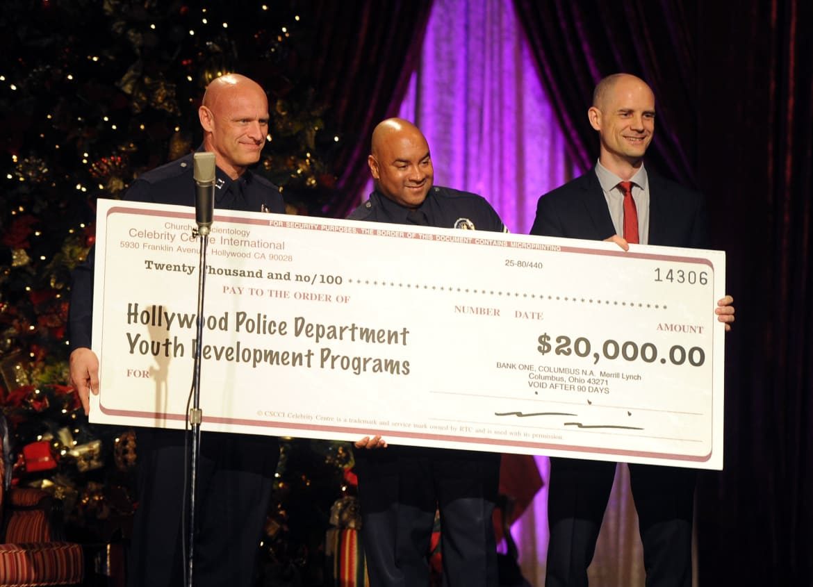 Click to enlarge cops and scientologists present big cheque