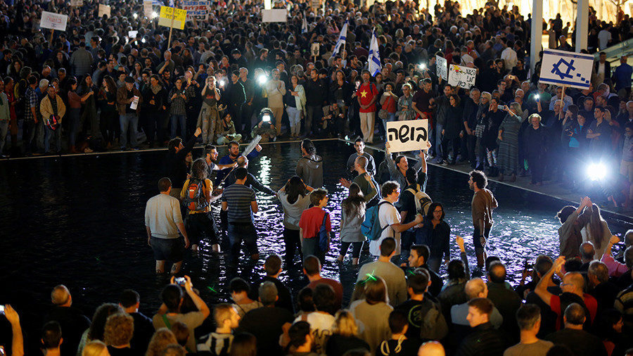Israelis take part in a protest against corruption in Tel Aviv