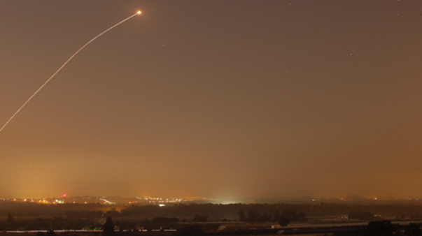 Click to enlarge An interception by the Iron Dome anti-missile system is seen as rockets are launched from Gaza towards Israel