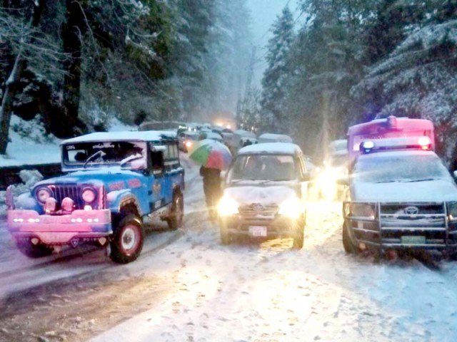 Vehicles wait for the snow-covered roads to open in Murree