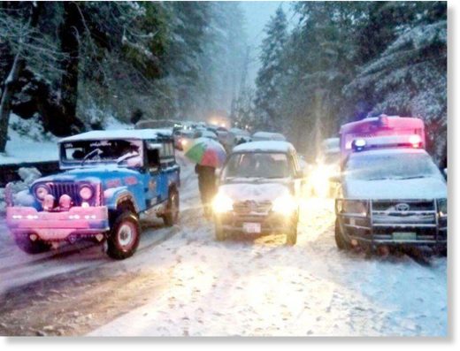 Vehicles wait for the snow-covered roads to open in Murree