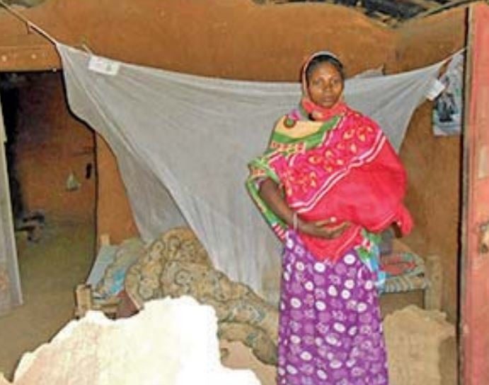 Shanti with her newborn, in their damaged house in Biramitrapur on Monday.