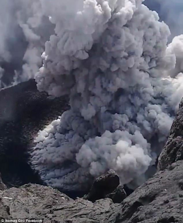 The man appears to be standing right above the heart of Mount Agung as the volcanic lava threatens to explode from its fiery depths