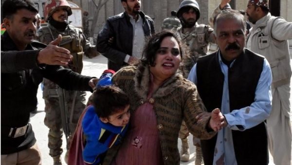 A police man directs families to safety following the terrifying attack in Bethel Memorial Methodist Church in Quetta, Pakistan Dec. 17. | Photo: Reuters