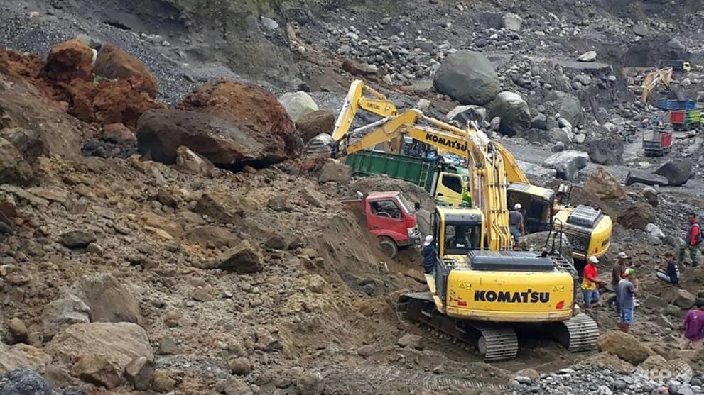 Click to enlarge Rescuers are using heavy machinery to search for survivors after the landslide on the slopes of Mount Merapi