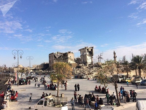 Click to enlarge Residents on a street in Aleppo