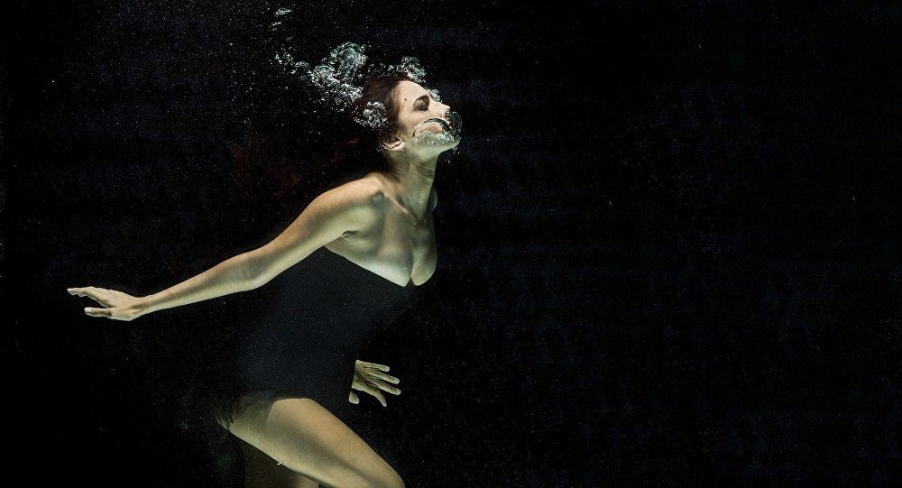woman swimming underwater