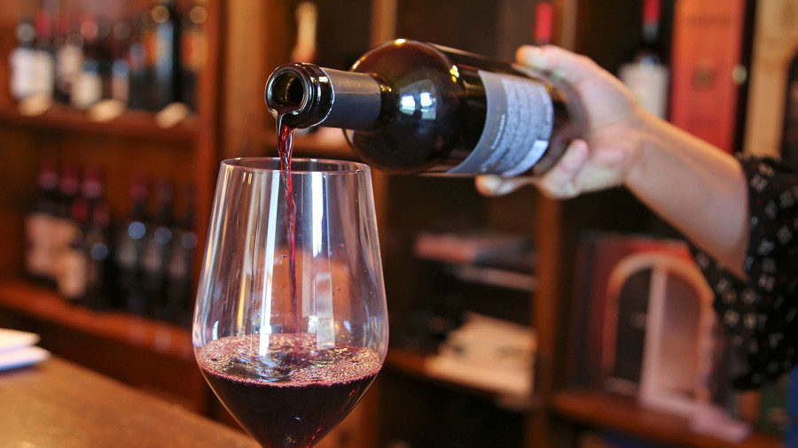 Click to enlarge pouring glass of red wine