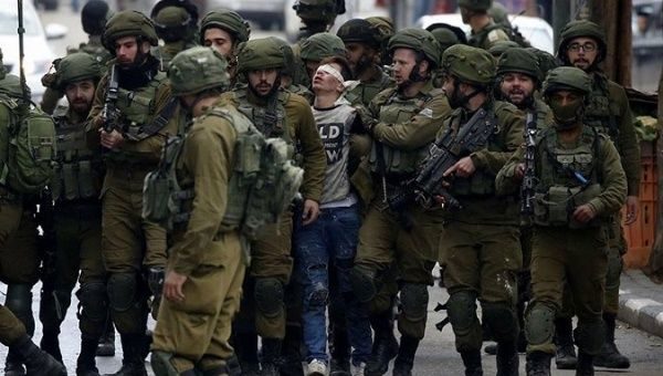 Palestinian teenager boy Israeli soldiers viral photo