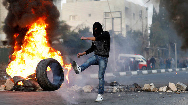 Palestinian demonstrator hurls stones