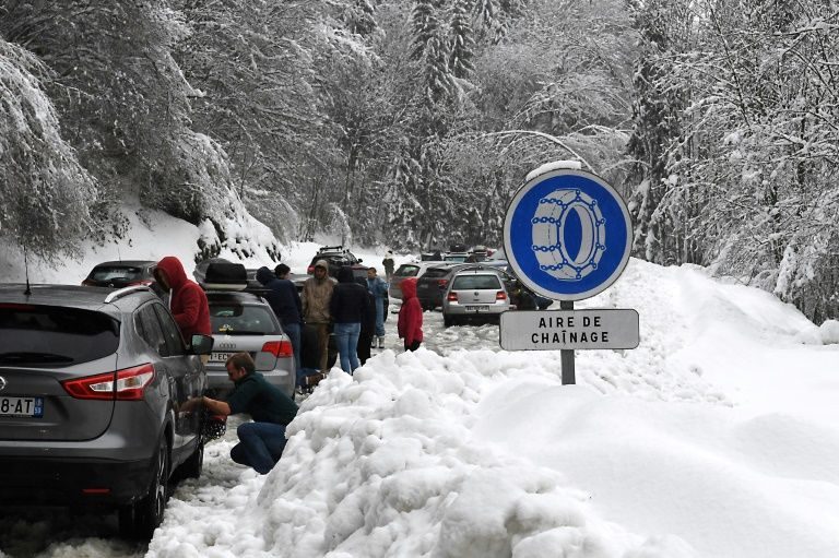Snow made some roads impassable in the French Alps and forced these motorists to put chains on their wheels