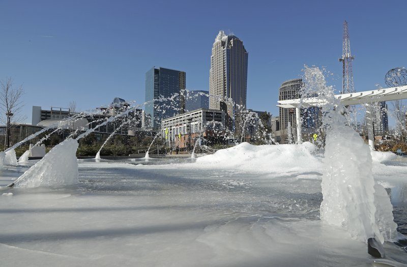 Water squirts from a frozen fountain near downtown in Charlotte, N.C.,
