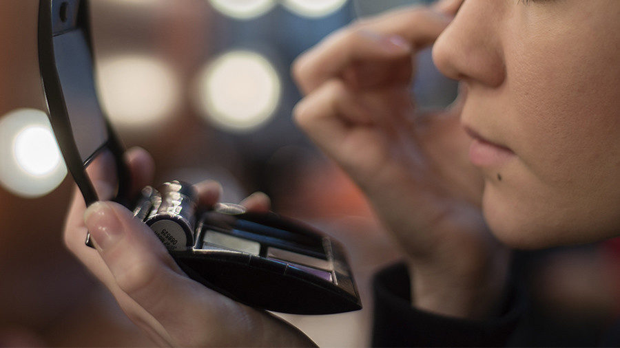 Click to enlarge applying makeup