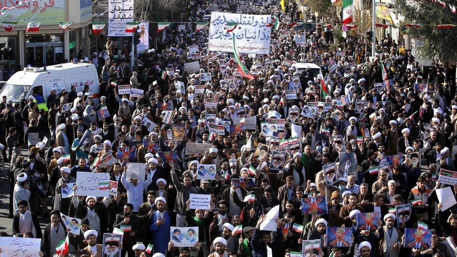 Pro-government demonstrators march in Iran's holy city of Qom on January 3, 2018