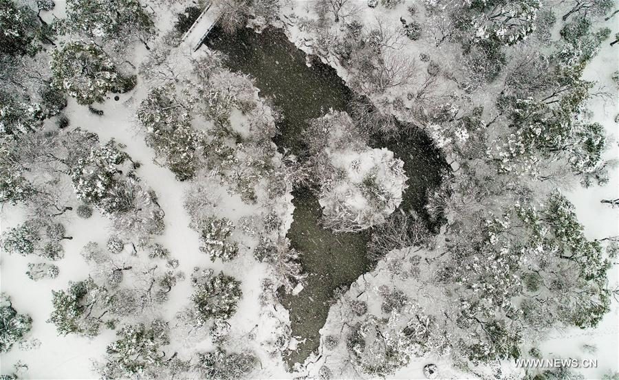 Aerial photo taken on Jan. 4, 2018 shows the snowy view at the Feicui Lake Park