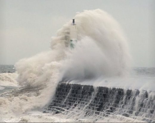Waves crash over the stone jetty wall in Aberystwyth in west Wales as Storm Eleanor lashed Britain with violent storm-force winds of up to 100mph, leaving thousands of homes without power and hitting transport links Wednesday Jan. 3, 2018.