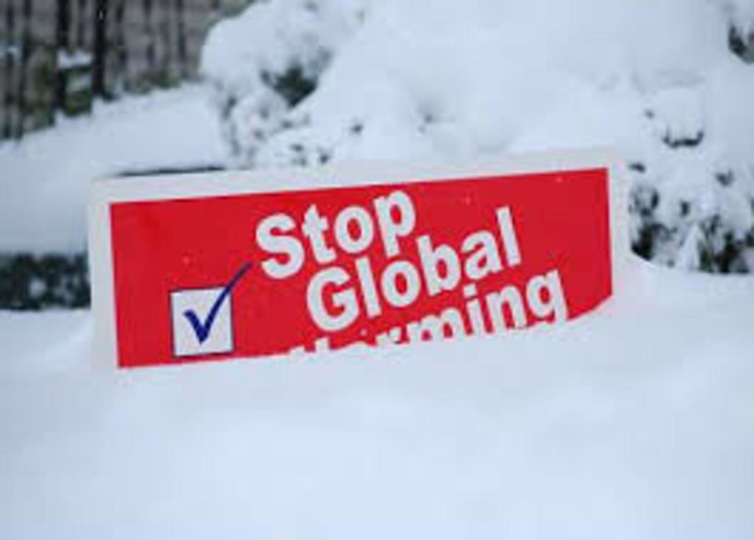 Stop global warming sign under snow