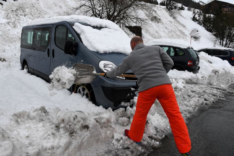 A man shovels snow in Les Menuires, France, on January 4