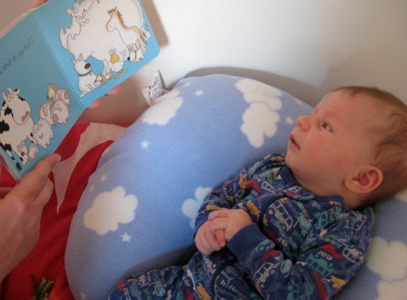 Click to enlarge baby being read to