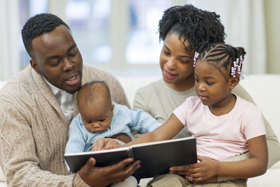 parents reading to baby