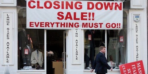 A man passes a clothing shop holding a closing down sale in London October 20, 2010.