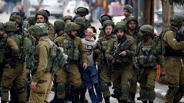 Click to enlarge Palestinian teen Fawzi Al-Junaidi being arrested