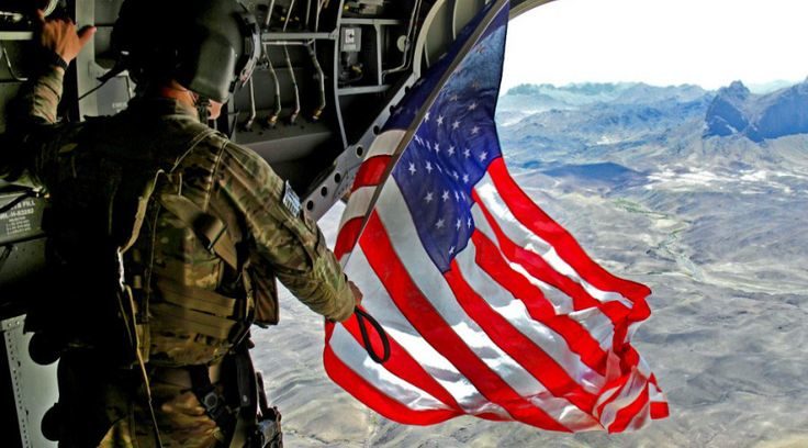 Click to enlarge US soldier waving US flag over Afghanistan