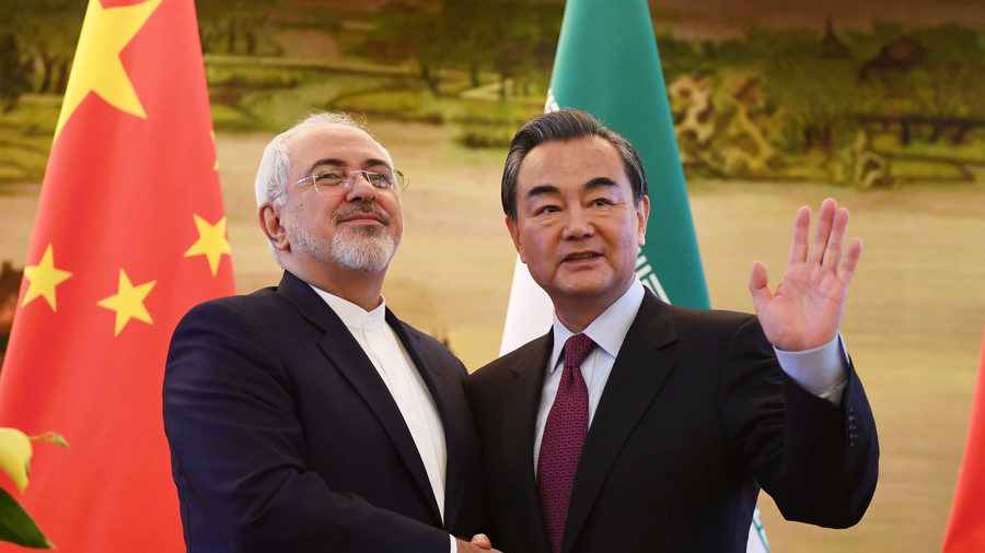 Iranian FM Mohammad Javad Zarif shakes hands with his Chinese counterpart Wang Yi