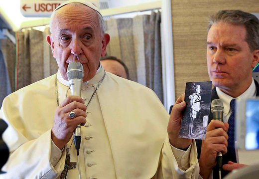 Click to enlarge Pope Francis holds a picture depicting a victim of the 1945 atomic bombing in Nagasaki as he speaks to reporters onboard the plane for his trip to Chile and Peru January 15, 2018