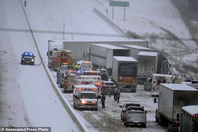 Emergency personnel remove patients for transport to area hospitals at the scene of a multi-vehicle wreck on Interstate 65 near Bonnieville, Ky., Tuesday, Jan. 16, 2018.