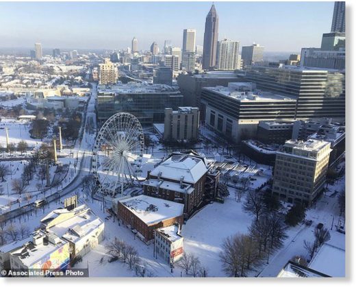 A snow covered downtown is seen, Wednesday, Jan. 17, 2018, in Atlanta.