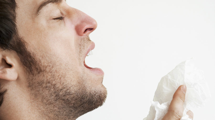 Man sneezes