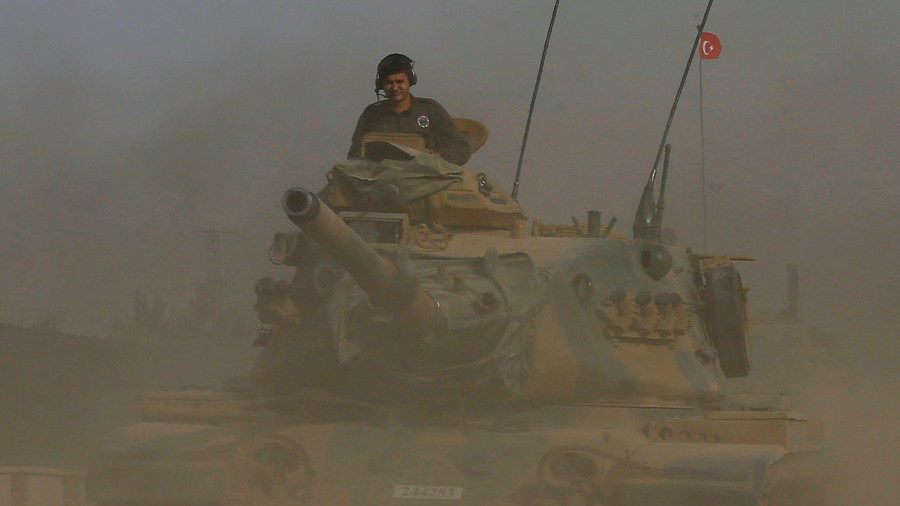 A Turkish army tank drives towards the Turkey-Syria border