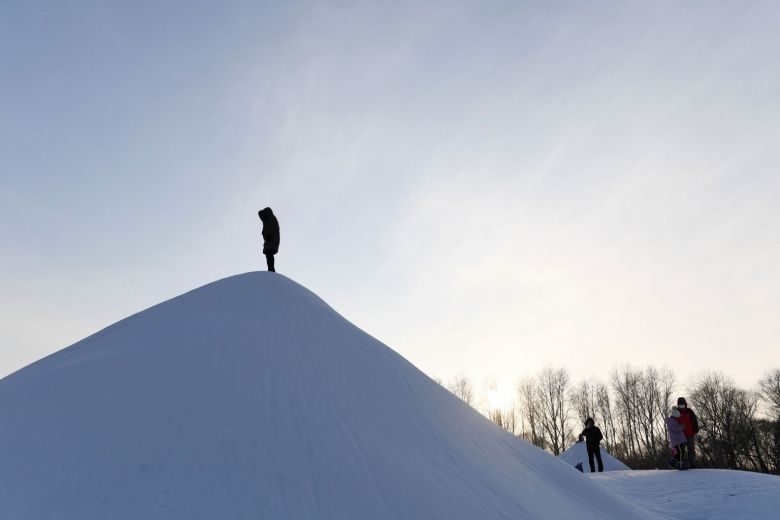 Click to enlarge A visitor climbs a snow hill before the opening of the annual Harbin Ice and Snow Sculpture Festival in Harbin in China's northeast Heilongjiang province, on Jan 5, 2018