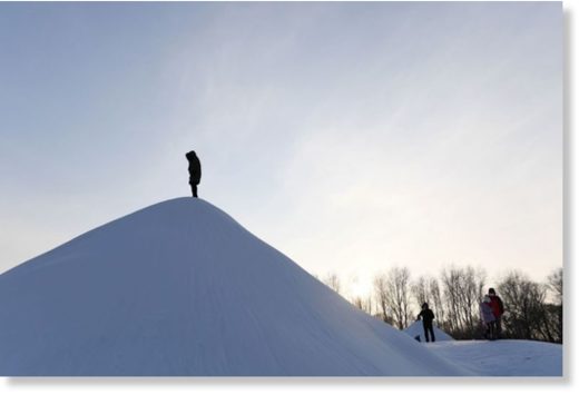 Click to enlarge A visitor climbs a snow hill before the opening of the annual Harbin Ice and Snow Sculpture Festival in Harbin in China's northeast Heilongjiang province, on Jan 5, 2018