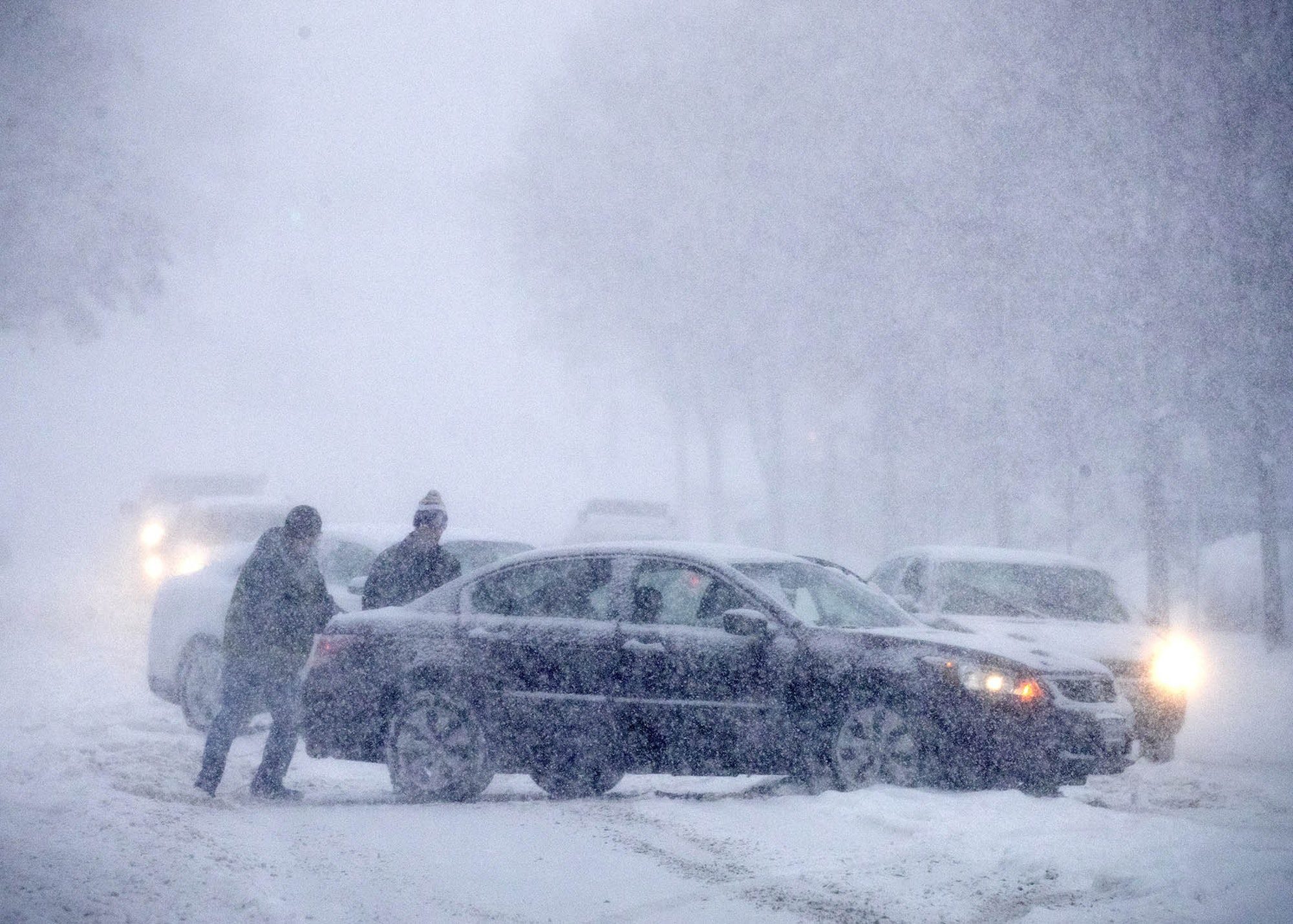 Click to enlarge A car stuck halfway up the hill on Ramsey Street gets a push from a good samaritan.