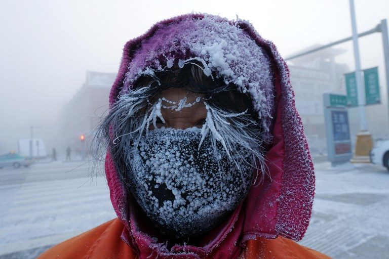 Click to enlarge This photo taken on January 24, 2018 shows ice forming on the face of a Chinese sanitation worker on a cold winter day in Hulun Buir, northern China’s Inner Mongolia region.