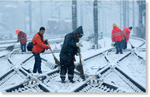 Click to enlarge Employees of the Nanchang Railway Bureau, in Jiangxi province, clean snow from the tracks on Jan. 25, 2018.