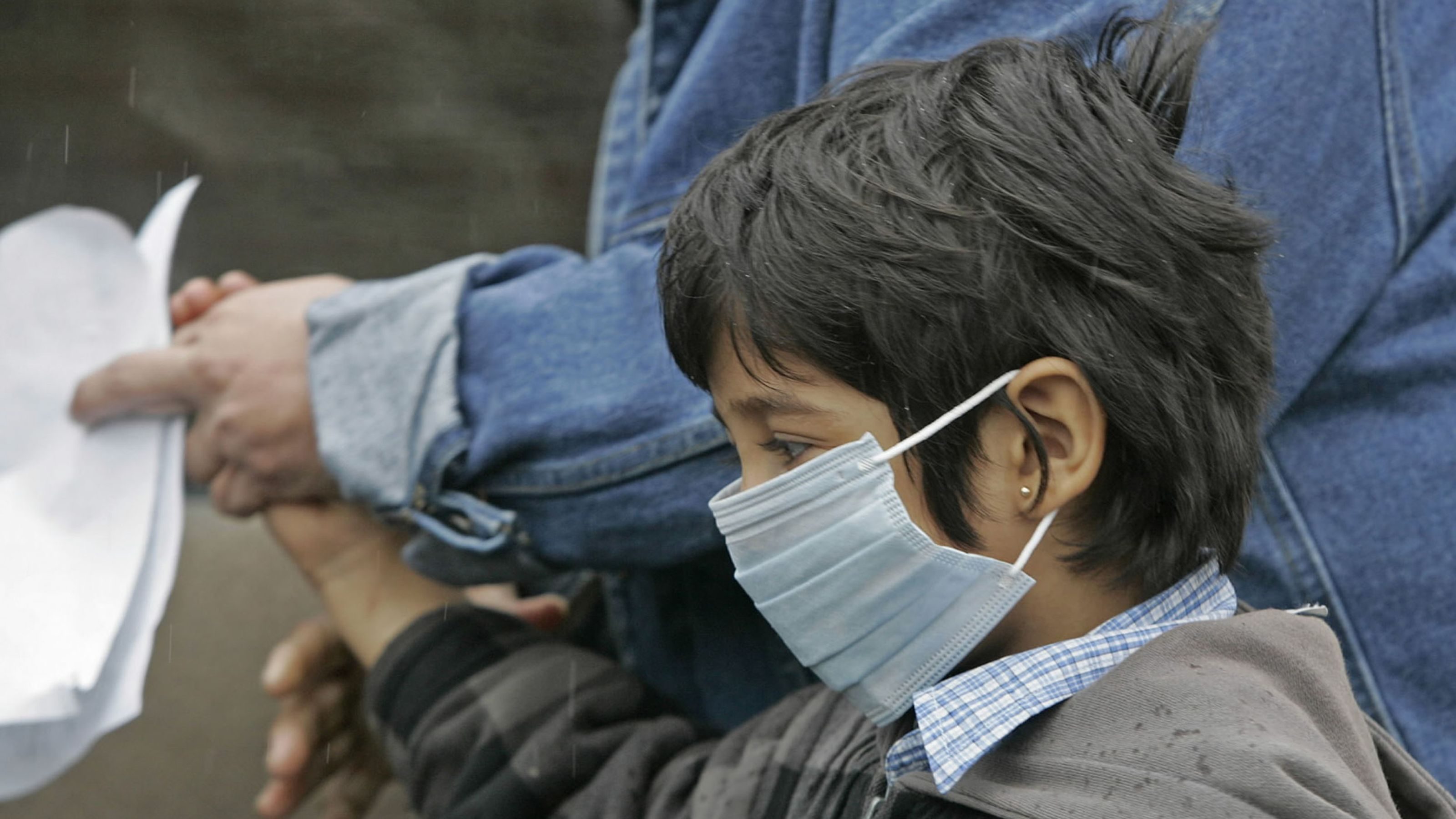 child with flu mask