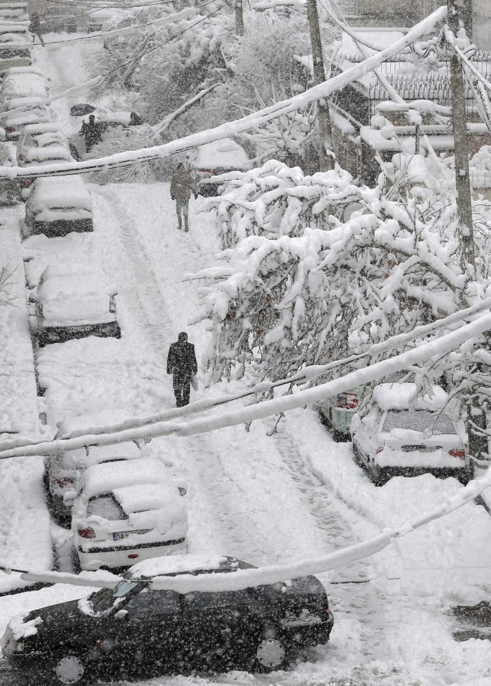 Click to enlarge An Iranian man walks amid the snow in the capital Tehran