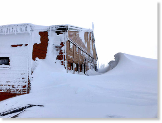 Click to enlarge Fourteen-foot snow drifts were sculpted by high wind near the visitor center at Hurricane Ridge in the photograph taken Friday.