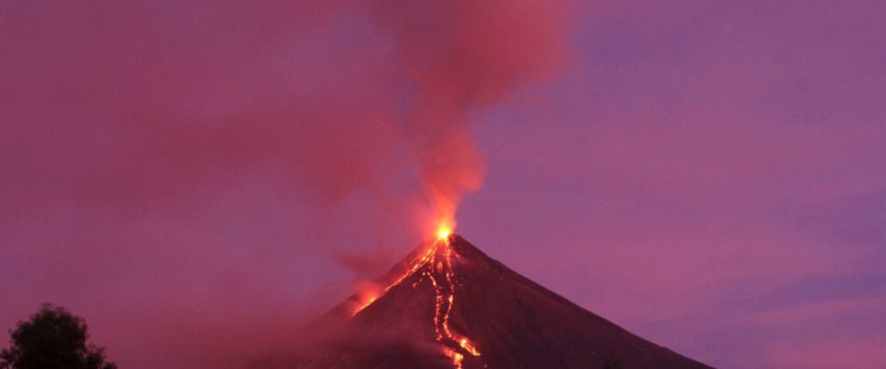 Molten lava flows down the slopes of Mayon volcano during its mild eruption as seen from Legazpi city, Albay province, southeast of Manila, Philippines Tuesday, Jan. 30, 2018