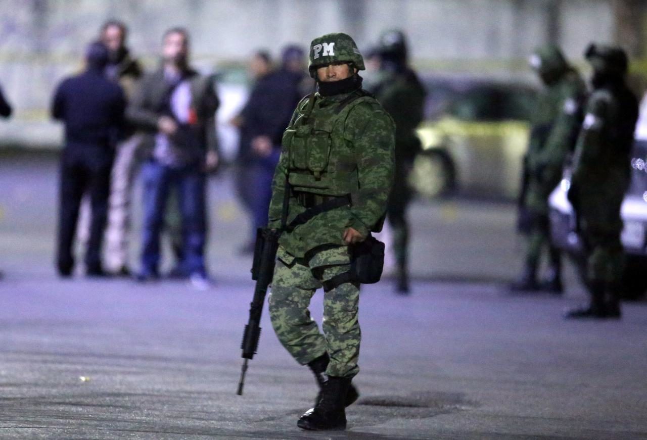 Click to enlarge soldier stands guard next to a crime scene