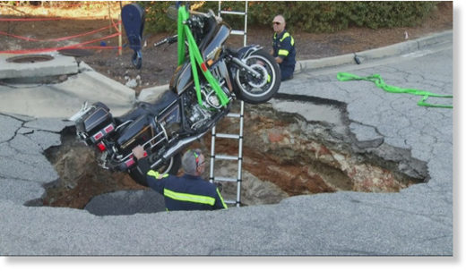 Motorcyclist falls into sinkhole