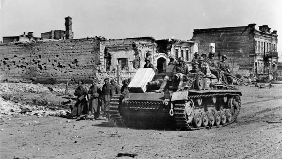 German troops riding on a StuG III assault gun