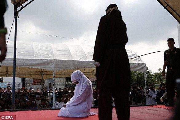 Click to enlarge An Acehnese woman was also lashed as part of the public caning on Friday outside a mosque after prayers had finished