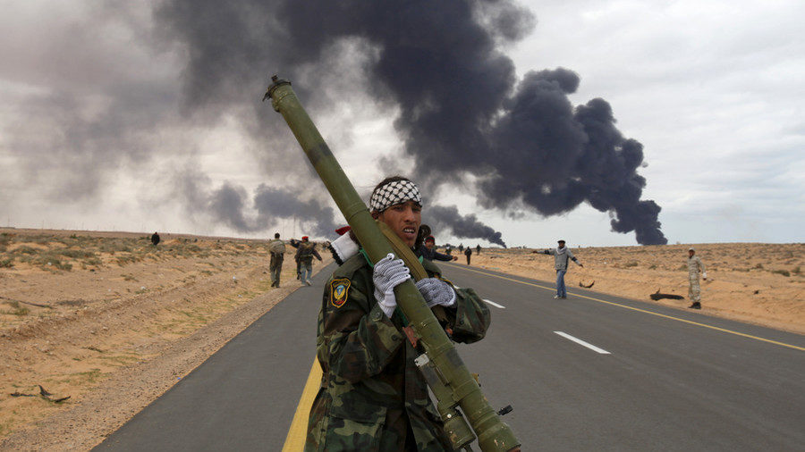 Click to enlarge A rebel holds a man-portable air-defense system