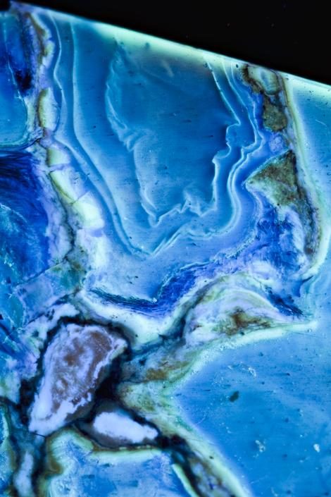 Click to enlarge Amber will fluoresce under ultraviolet light, revealing the individual resin flows around the bird trapped inside.