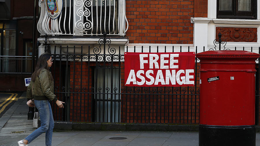 Click to enlarge woman walks past a sign that reads