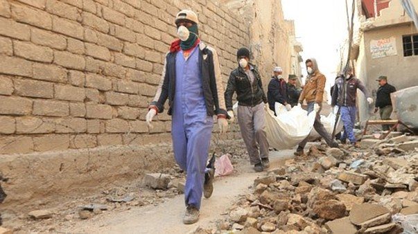 Local residents carry bodies
